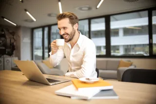 A person working at a table in a cafe