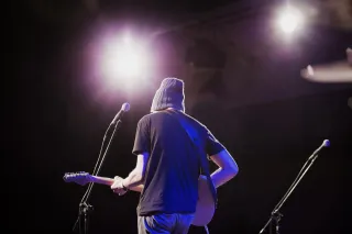 A performer with equipment on a concert stage
