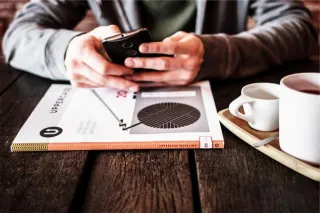 A person considering work information at a table