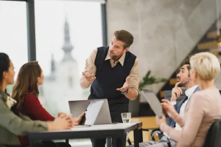 People discussing work around a table