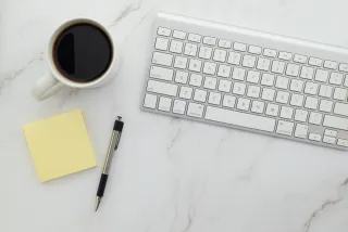 A keyboard and desk accessories