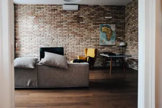 A furnished interior with a brick wall