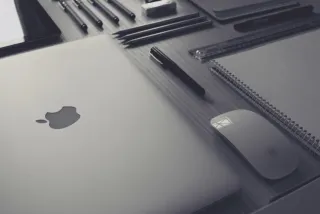 A laptop and accessories on a work surface