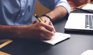 A person reviewing paperwork while working
